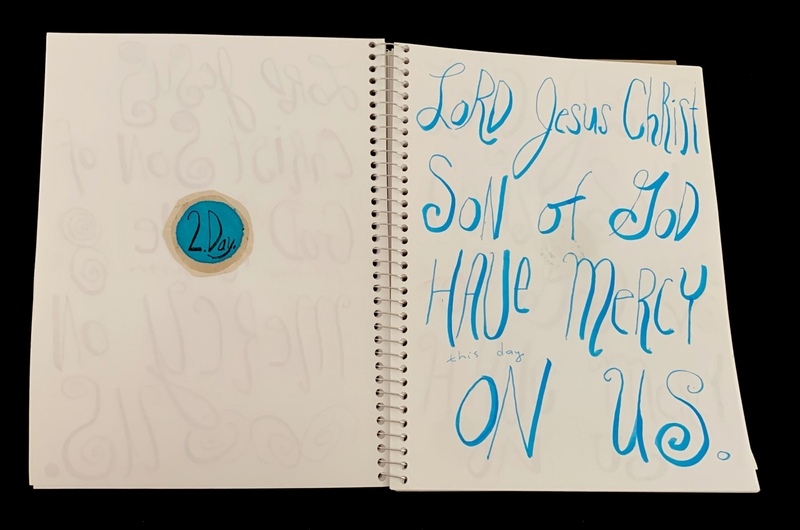 A handwritten prayer page with a decorative circular design and a handwritten inscription.