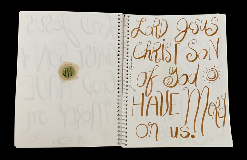 A handwritten page featuring a prayer and a wax seal.