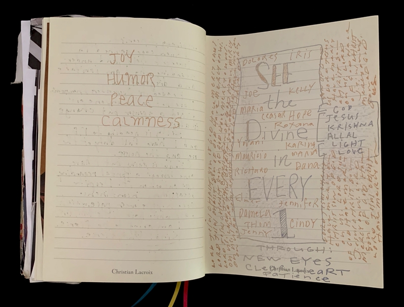 Open journal with handwritten words, art, and faint text, featuring the phrases "Joy," "Humor," "Peace," "Calmness," "SEE the Divine in EVERY 1" among other names and words.