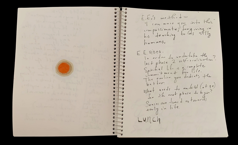 A handwritten page from a spiral notebook with a small orange circle and text discussing spiritual life and self-realization.