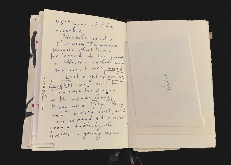 An open notebook with handwritten blue ink text and an inserted folded paper labeled "Karen."