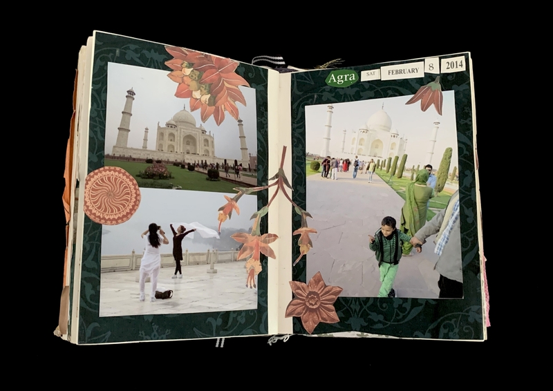A scrapbook spread with two pages featuring photos of the Taj Mahal and decorative floral elements.
