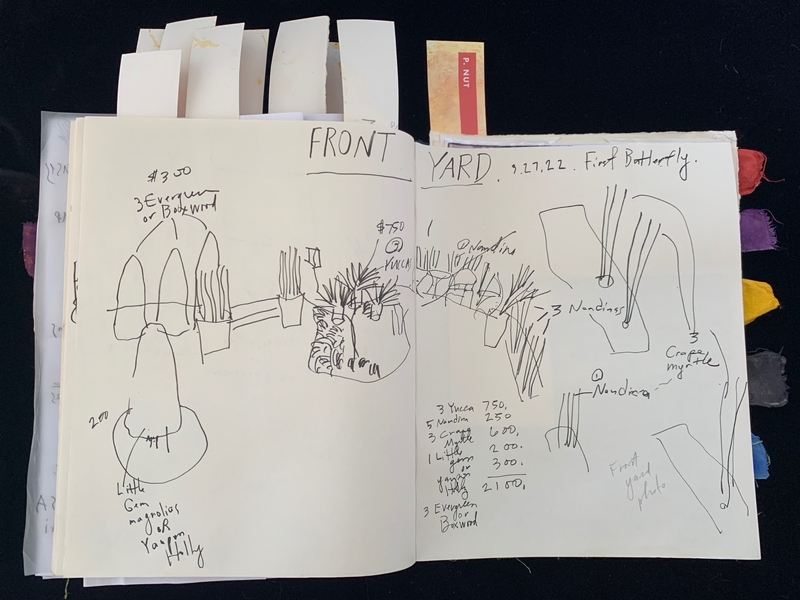 Open journal with plant sketches and handwritten garden layout notes.