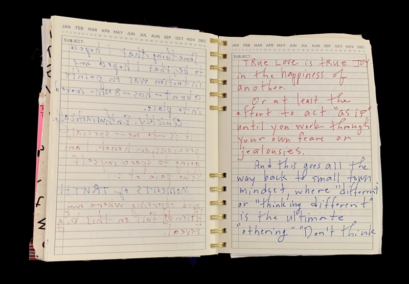 A handwritten notebook page with various entries and a quote about true love.