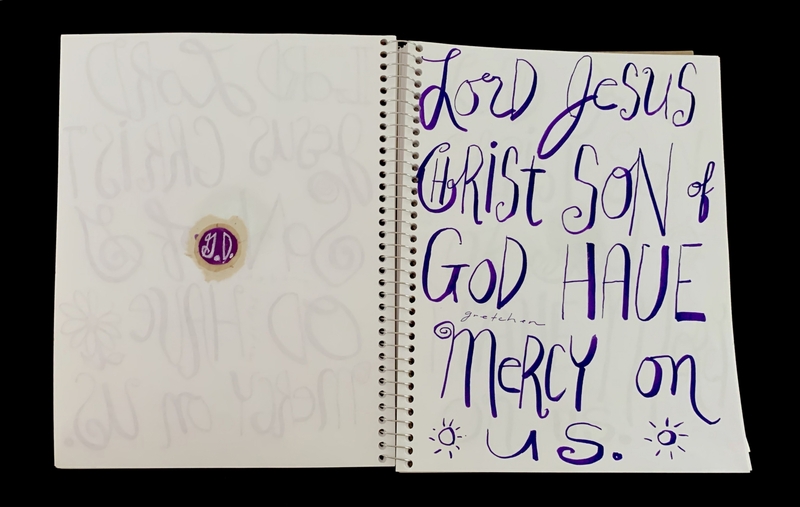 A handwritten prayer page featuring a religious inscription and decorative elements.