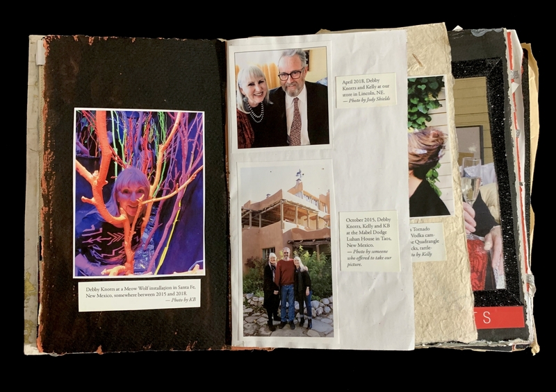 An open scrapbook with photos and captions, featuring images at Meow Wolf in Santa Fe, Lincoln, NE, and Taos, NM.