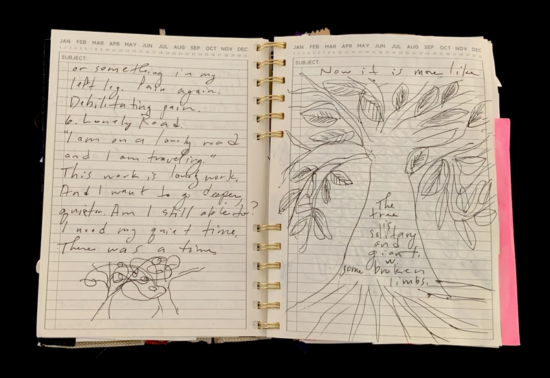A journal page with handwritten notes and a sketch of a tree.
