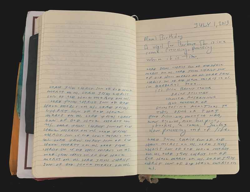 Open notebook with handwritten text on lined pages.