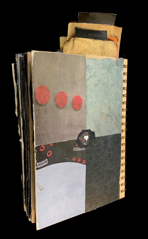 A mixed-media art piece featuring a variety of textures and colors, including red circles and a black and white patterned section.