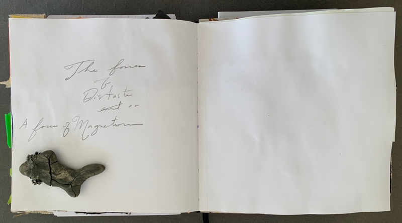 A journal page with handwritten text and a small, abstract drawing.