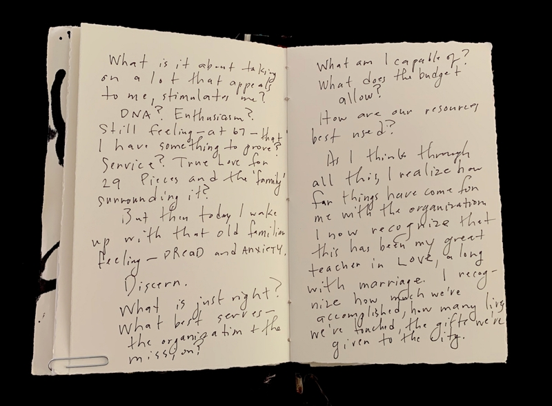 An open journal with handwritten reflections across two pages.