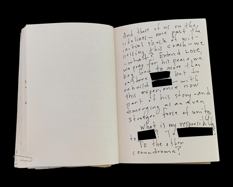 Open notebook with handwritten text and some blacked-out sections on the right page, left page is blank.