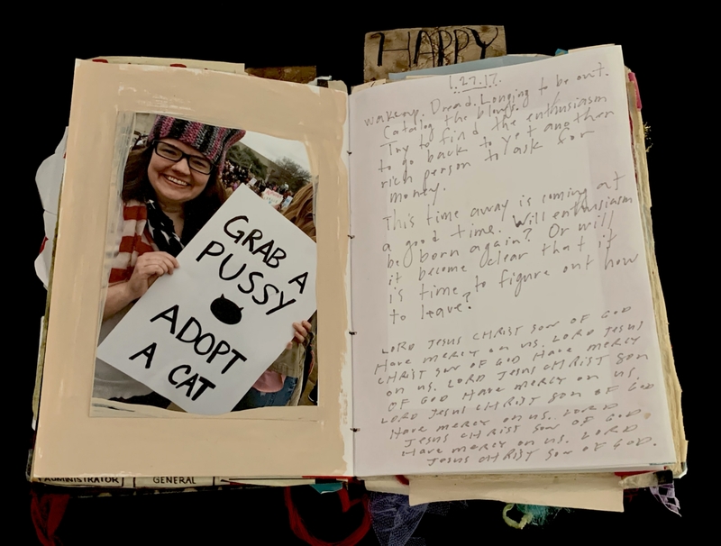 A handwritten journal page featuring a photograph of a person holding a sign and handwritten text discussing personal reflections and religious sentiments.