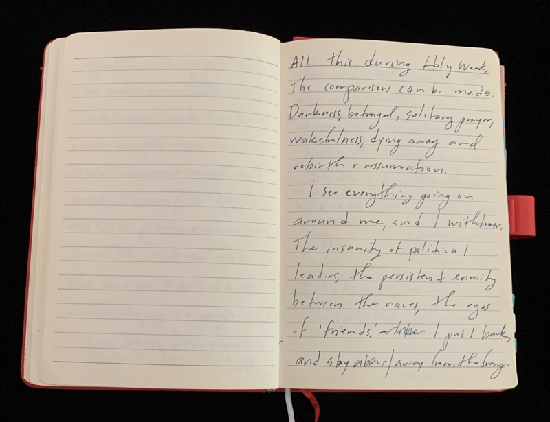 Open notebook with writing on the right page.