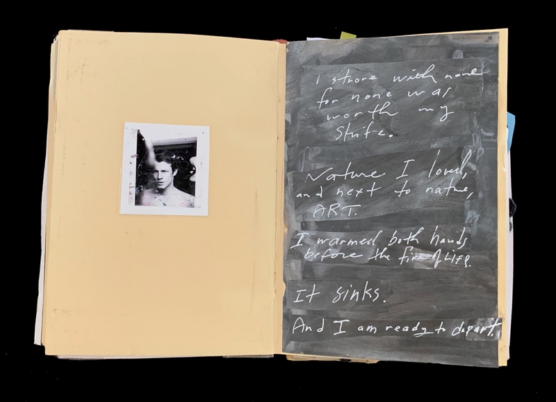 A handwritten page with a Polaroid photo and a chalkboard-style background.
