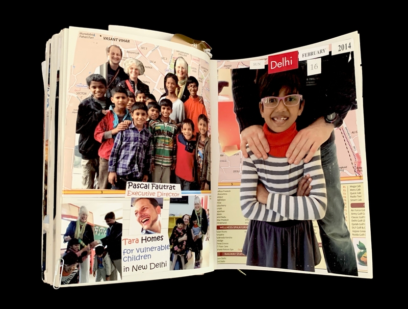 A scrapbook page featuring photographs and text related to Pascal Fautrat and Tara Homes for vulnerable children in New Delhi.