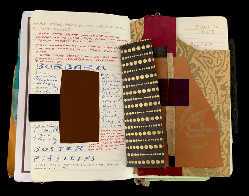 An open notebook with handwritten notes and decorative papers.