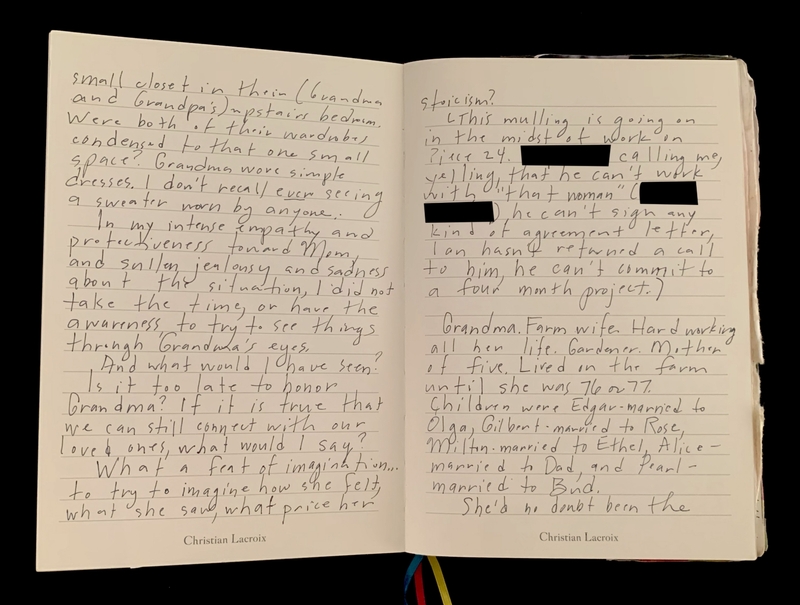 Open journal displaying handwritten text on lined pages.