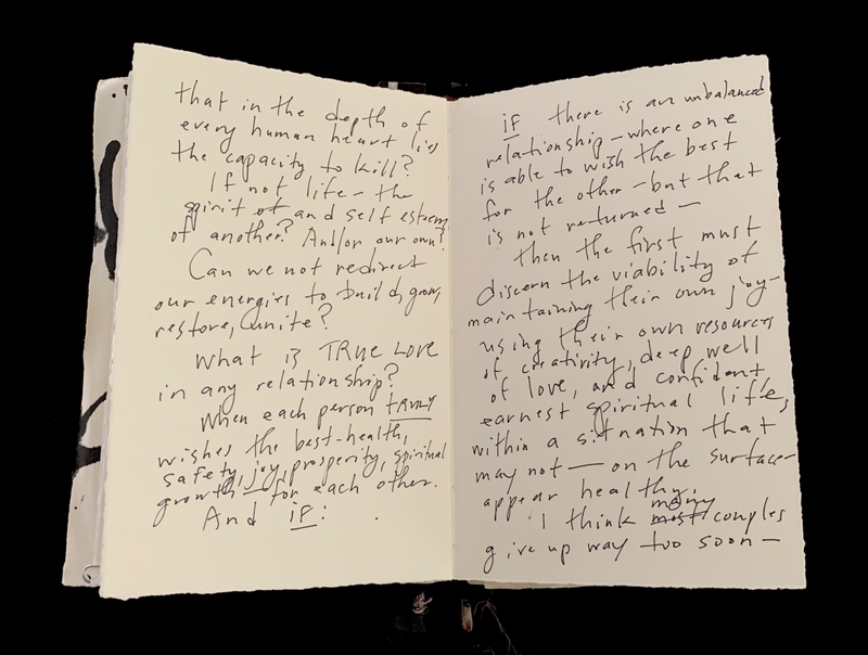 An open notebook with handwritten cursive text on both pages.