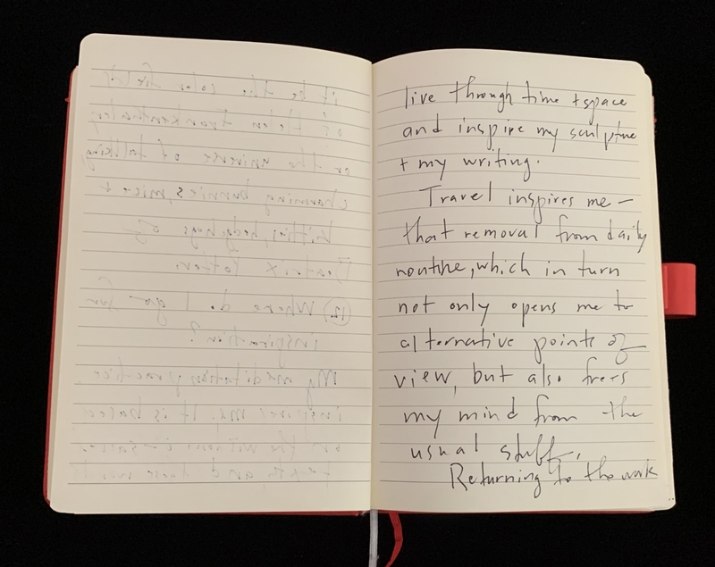 Open notebook with handwritten text on both pages.
