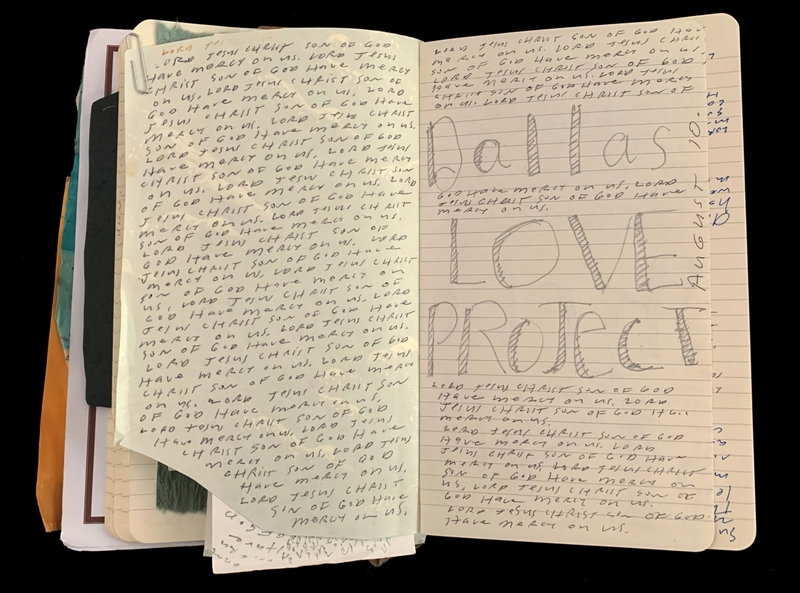 Open notebook with handwritten text and "Dallas LOVE PROJECT" in large letters.
