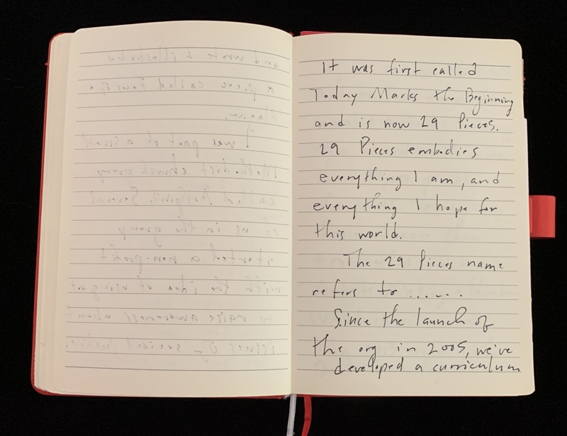 Open notebook with handwritten text on the right page and faint impressions on the left.