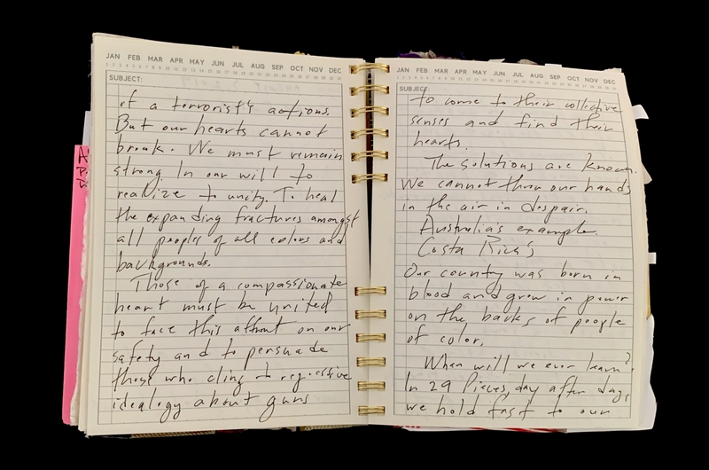 A handwritten notebook page with a focus on themes of unity, compassion, and the impact of terrorism.