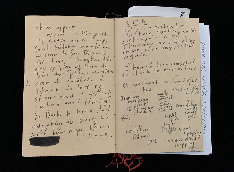 Open journal with handwritten notes on two pages.