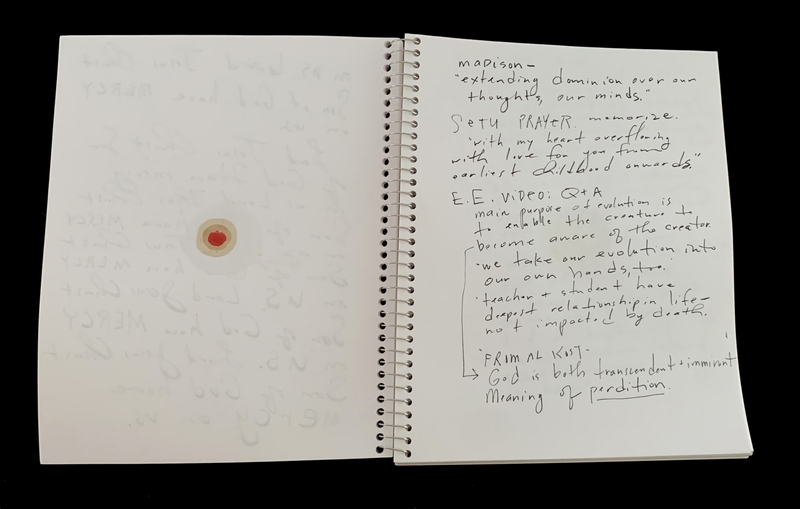 A handwritten notebook page with various notes and a small red heart doodle.