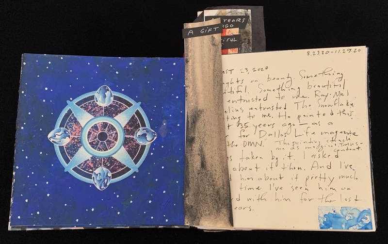 Open book with a blue geometric illustration on the left and handwritten notes on the right.