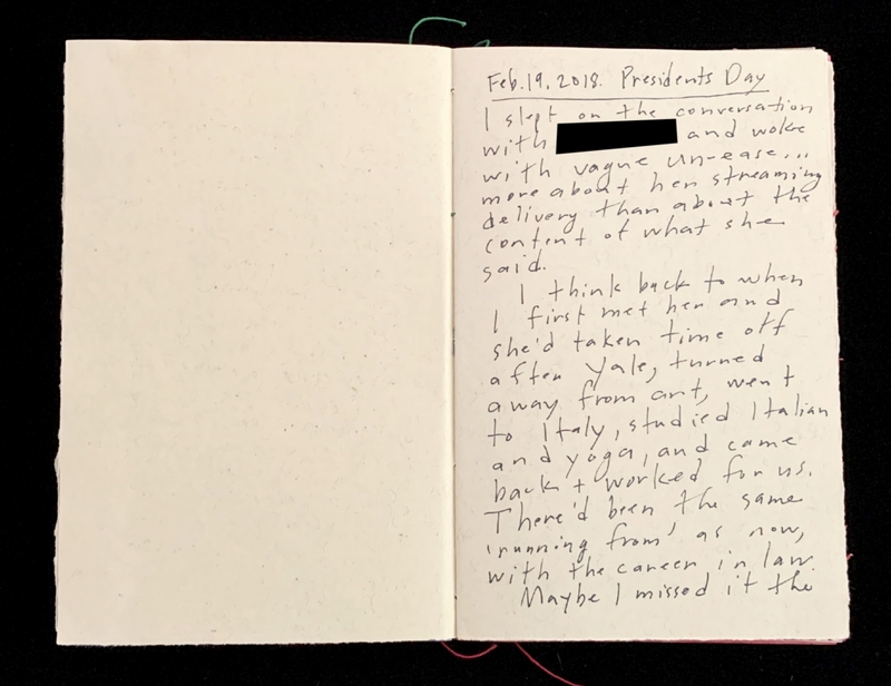 An open notebook with handwritten text on the right page.