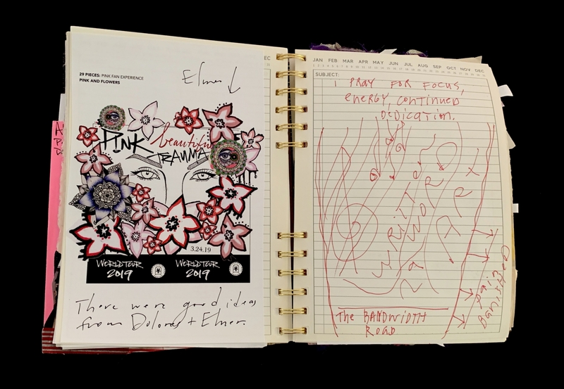 A creative spread in a planner featuring floral illustrations, handwritten notes, and a reference to a world tour.