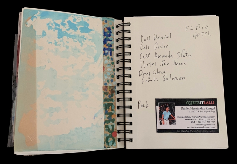 A spiral-bound notebook page with a watercolor background and handwritten notes.