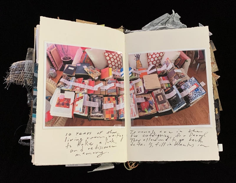 A photograph of a scrapbook page featuring a collection of small books and papers, with handwritten notes.