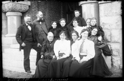 Professor Bessey (standing, second from left), Ellen Smith (seated, first on left, front) and students,  1895. View Image