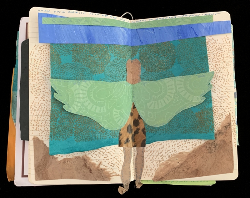Collage in an open journal with a figure with green wings, against a teal and gold background.