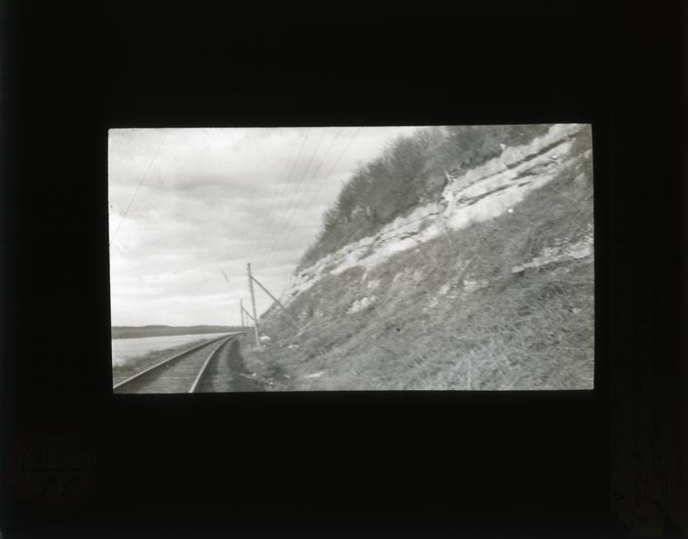 Original caption: XXIV-6 NAB. Apr. 14, 1912. Two lower l.s. in scarp west of Oreapolis. Basal ledge is the lowest in Nebraska series. Cass County. (121111-00227)