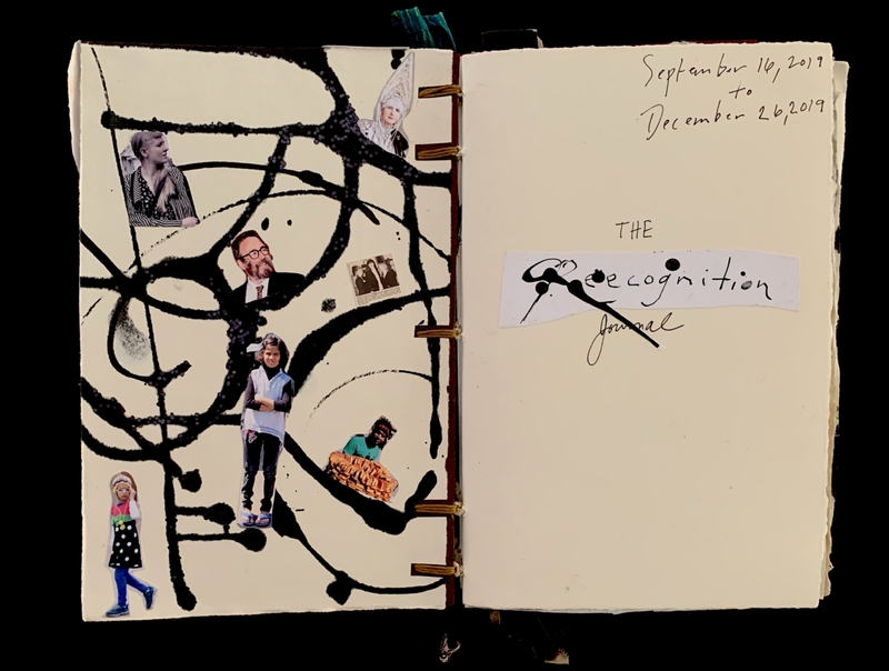 Open journal with black paint splatters and collaged photos on one page, handwritten text on the other.