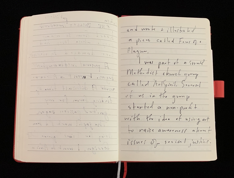 An open notebook with handwritten text on lined pages.