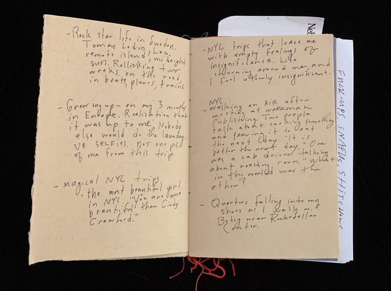 Open notebook with handwritten text on two pages.