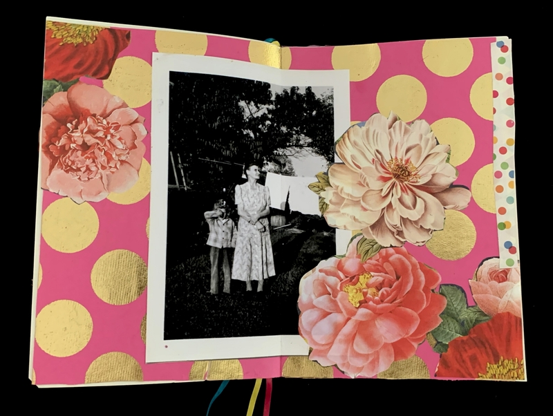 Open journal spread with a black-and-white photo centered on a pink background with golden polka dots and large flowers.