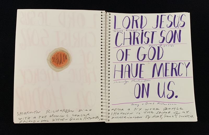 A memorial page with handwritten text and a sticker in memory of Sharolyn Richardson.