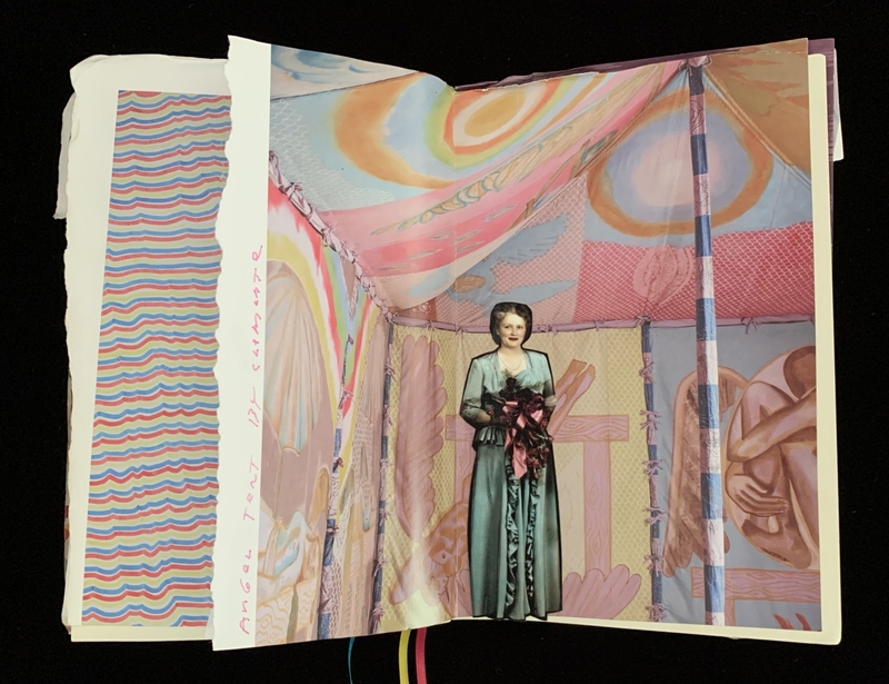 Open journal showing colorful art with a woman in a vintage dress against an abstract tent-like background.