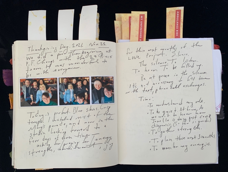 Open journal with handwritten notes and four photos on the left page, discussing Thanksgiving and personal reflections.