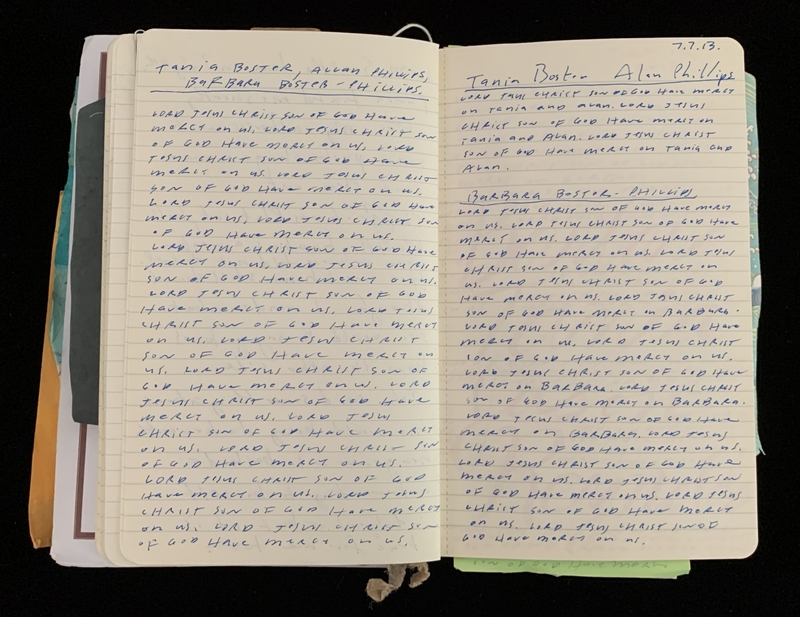 An open notebook with handwritten text in blue ink on two lined pages, dated 7.7.13.