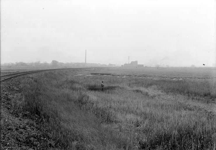 Original caption: Dried-up marsh, east end of Salt Basin. An unidentified man stands amid the marsh. Oct. 1918