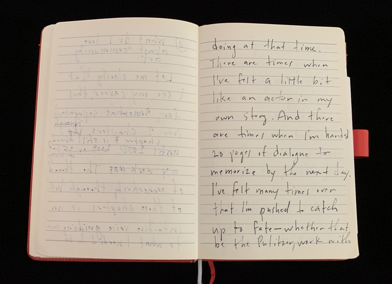 Open notebook with handwritten text on both pages; the left page is faint while the right page is clear.