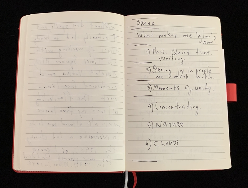 Open notebook with a red cover, displaying handwritten notes.