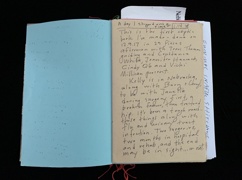 Open book with text on a beige page and a blank blue page.