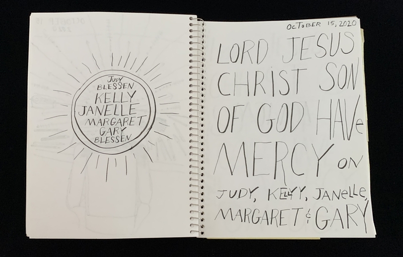 A handwritten page with a circular doodle and a prayer written in bold letters.